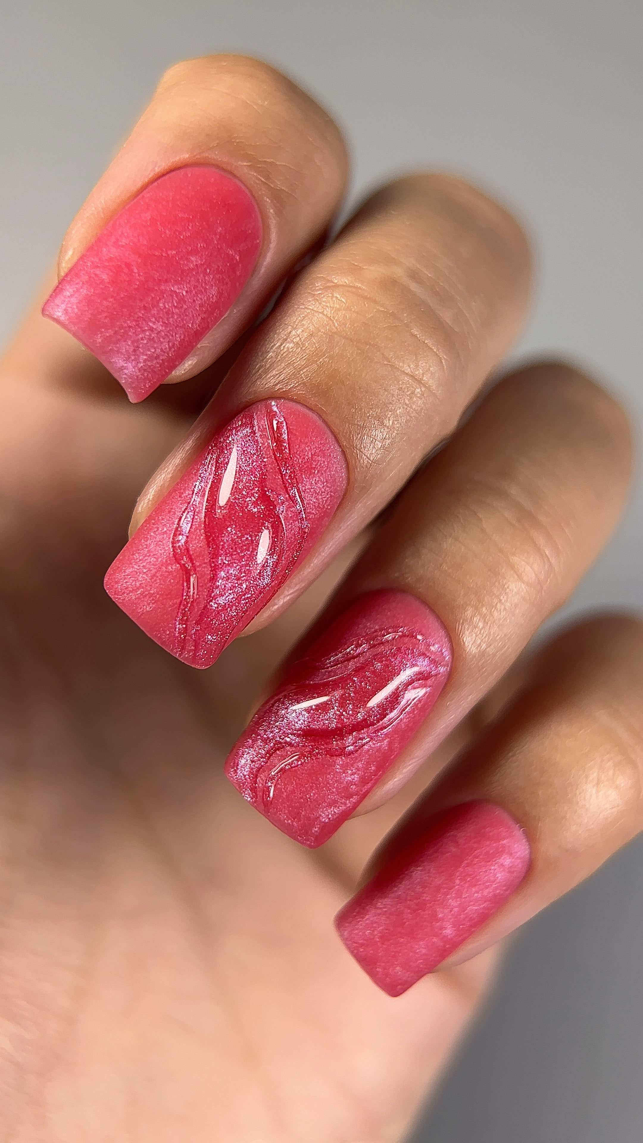Mini tutorial video demonstrating how to create a festive and eye-catching manicure using Paloma gel nail polish in shade C076, a vibrant red with a pink shimmering effect. This step-by-step guide shows the application of a unique textured design with a glossy and matte contrast, perfect for adding sparkle to holiday or special occasion nail art.